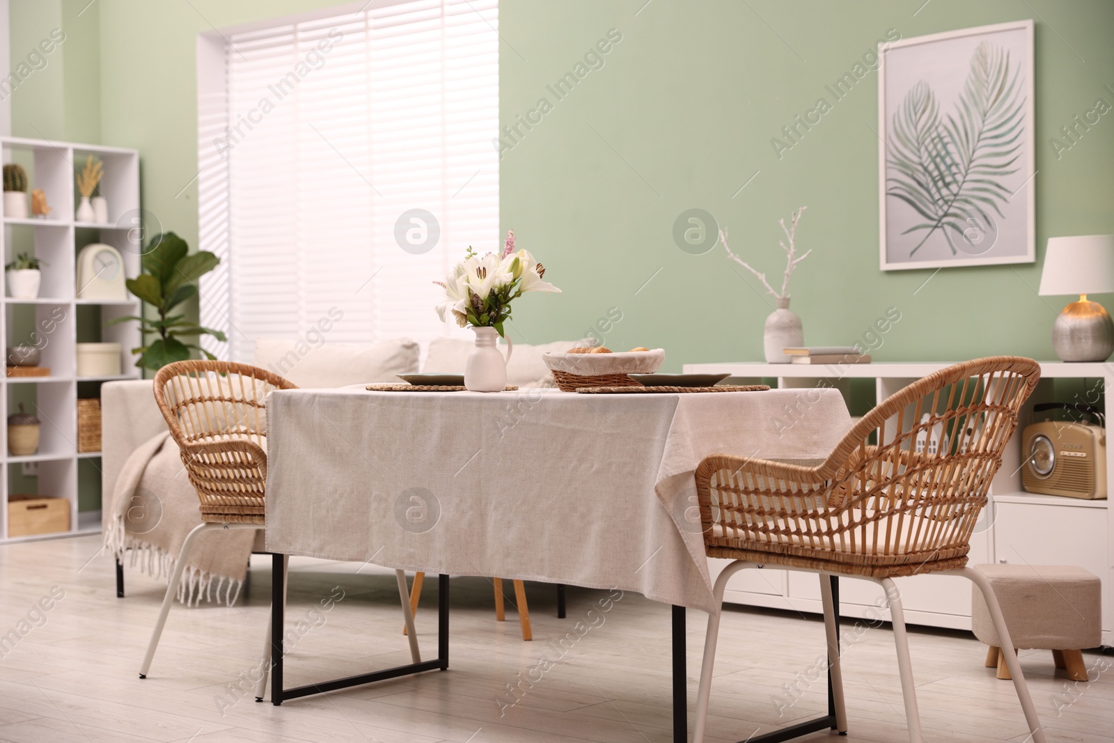 Photo of Stylish table with chairs and decor in dining room. Interior design