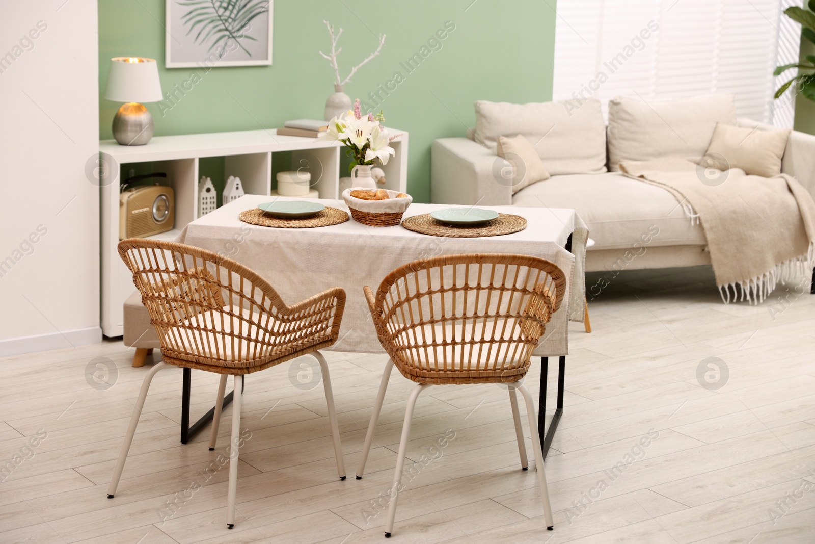 Photo of Stylish table with chairs and decor in dining room. Interior design