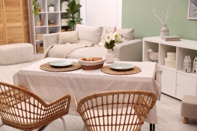 Photo of Stylish table with chairs and decor in dining room. Interior design