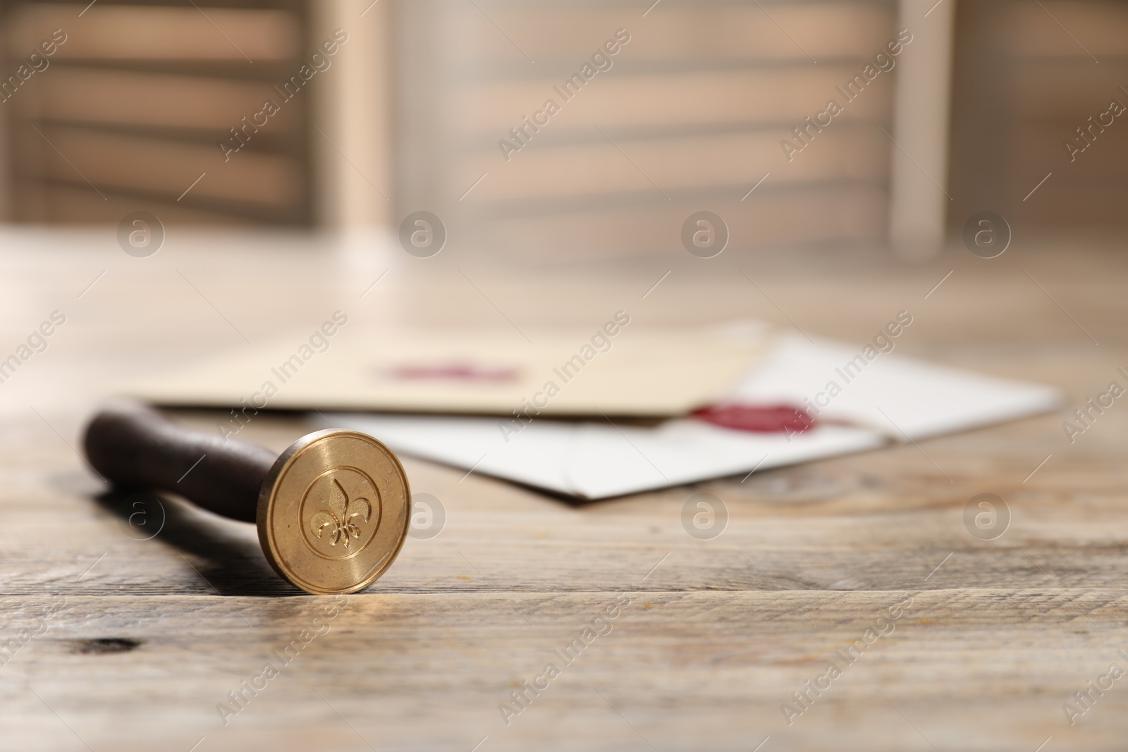 Wax stamp and envelopes on wooden table, closeup. Space for text Photo of Wax stamp and envelopes on wooden table, closeup. Space for text