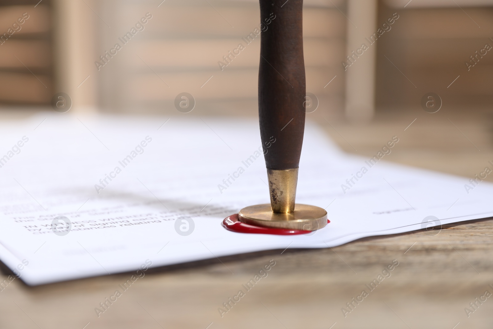 Documents with wax seal and stamp on wooden table, closeup Photo of Documents with wax seal and stamp on wooden table, closeup