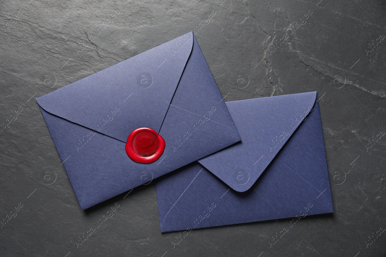 Envelopes with wax seal on black table, top view Photo of Envelopes with wax seal on black table, top view