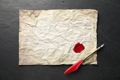 Photo of Crumpled paper with wax seal and fountain pen on black table, top view