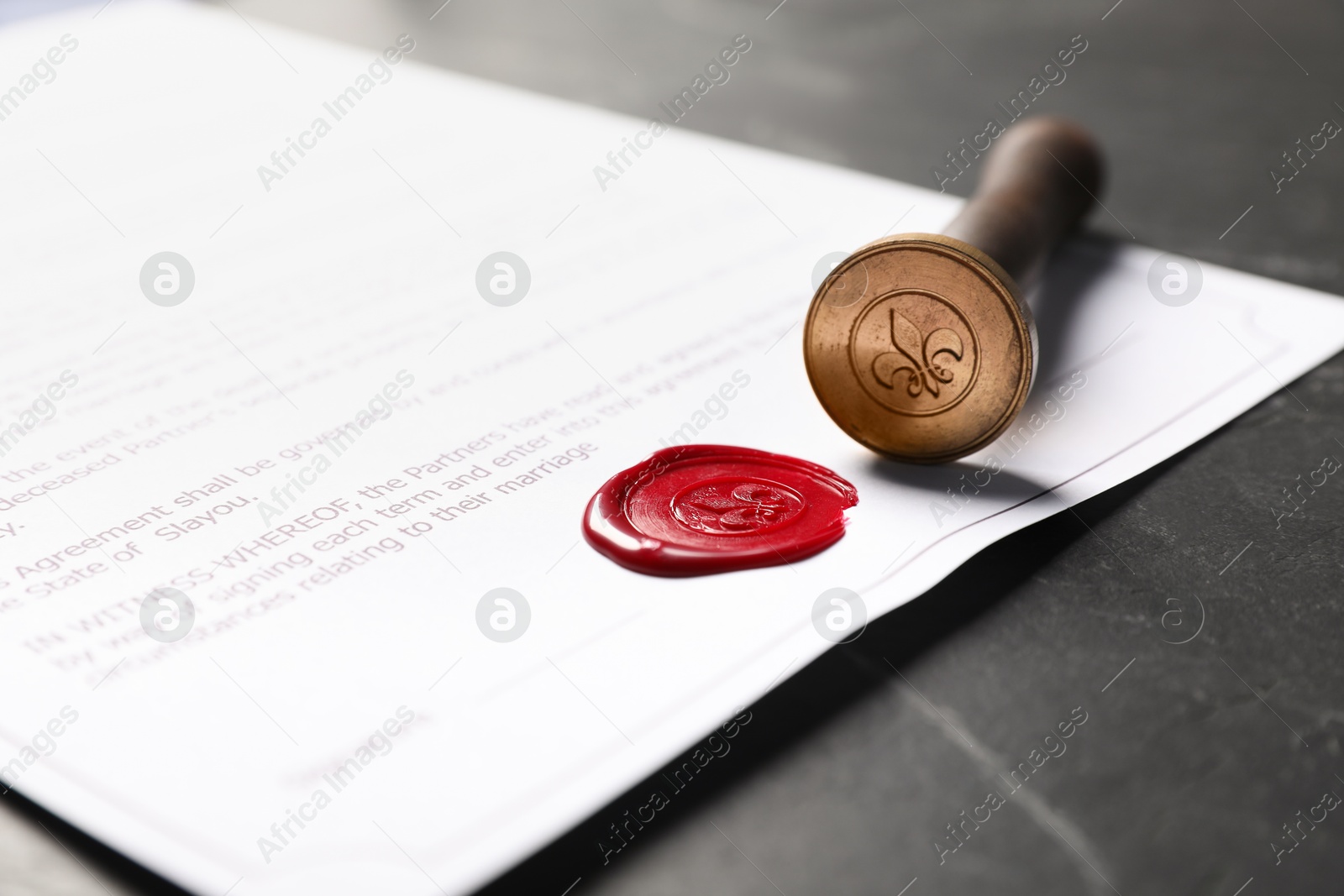 Document with wax seal and stamp on black table, closeup Photo of Document with wax seal and stamp on black table, closeup
