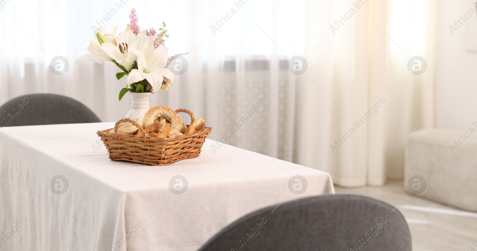 Photo of Stylish table with chairs and decor in dining room, closeup. Interior design