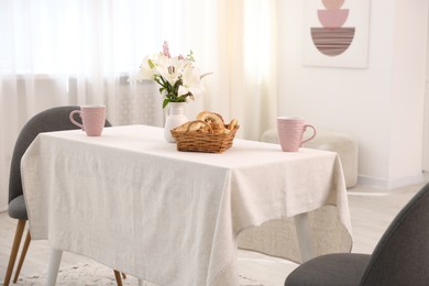 Photo of Stylish table with chairs and decor in dining room. Interior design