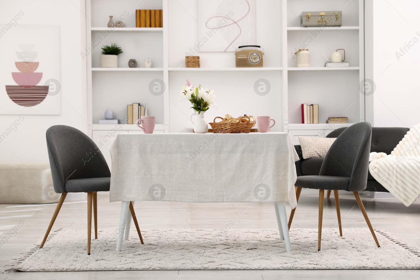 Photo of Stylish table with chairs and decor in dining room. Interior design