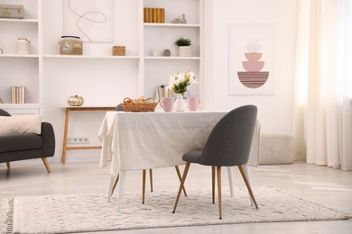 Photo of Stylish table with chairs and decor in dining room. Interior design