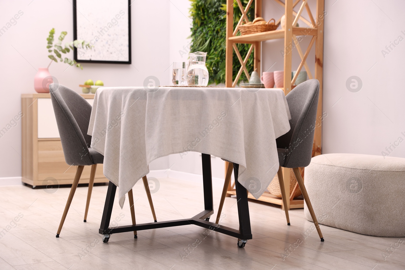 Stylish table with chairs and decor in dining room. Interior design Photo of Stylish table with chairs and decor in dining room. Interior design