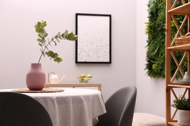 Photo of Stylish table with chairs and decor in dining room. Interior design