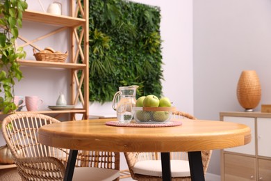 Photo of Wooden table with chairs and decor in stylish dining room, closeup. Interior design