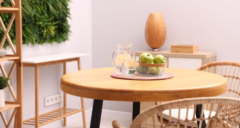 Photo of Wooden table with chairs and decor in stylish dining room. Interior design