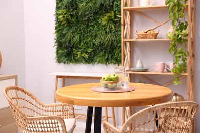 Photo of Wooden table with chairs and decor in stylish dining room. Interior design