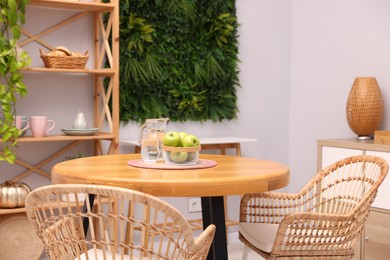 Photo of Wooden table with chairs and decor in stylish dining room. Interior design