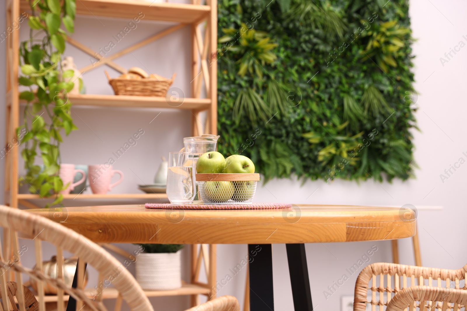 Wooden table with chairs and decor in stylish dining room, closeup. Interior design Photo of Wooden table with chairs and decor in stylish dining room, closeup. Interior design
