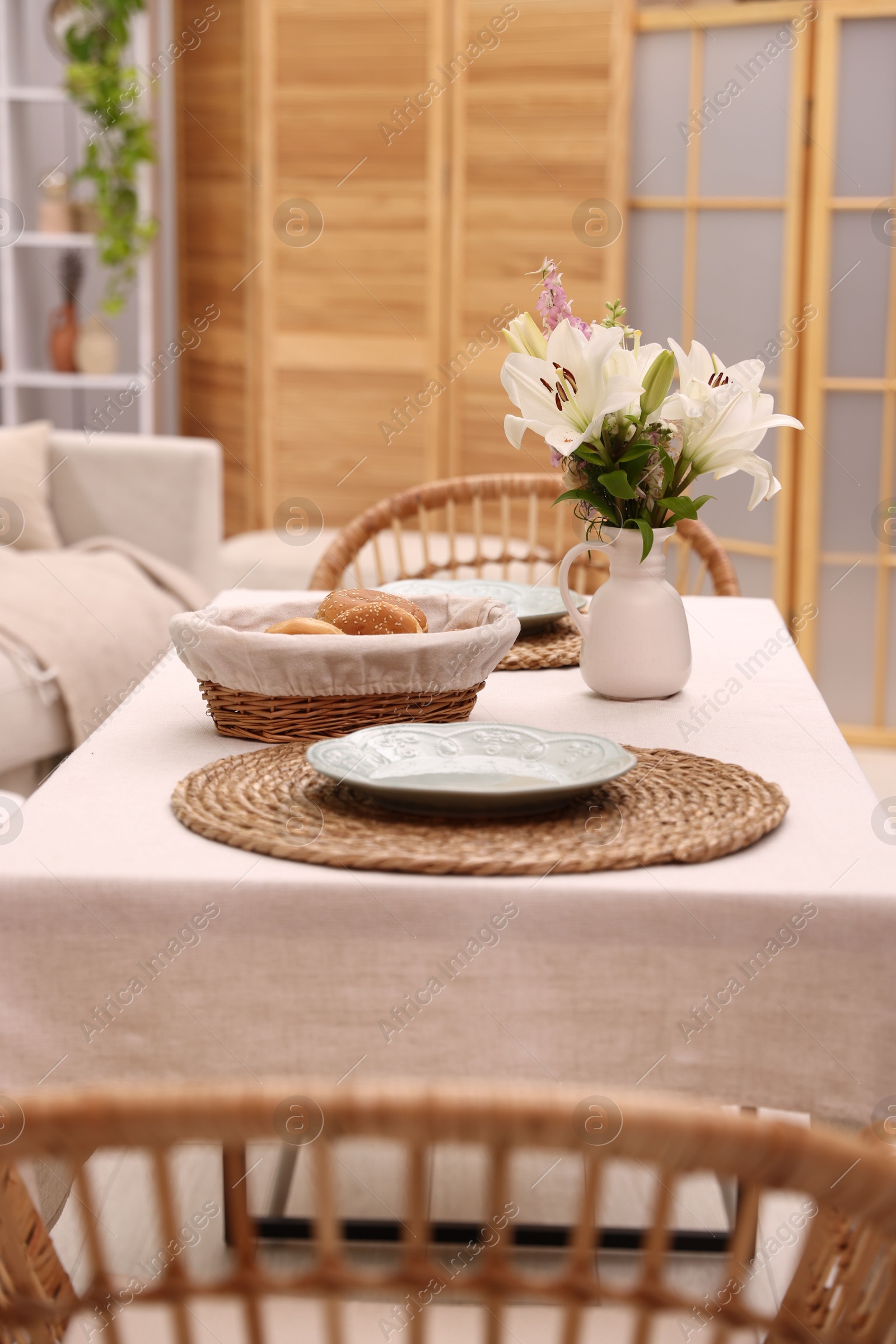 Photo of Stylish table with chairs and decor in dining room. Interior design