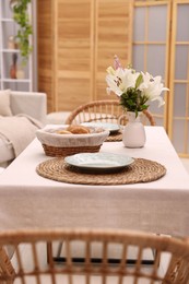 Photo of Stylish table with chairs and decor in dining room. Interior design