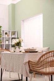 Photo of Stylish table with chairs and decor in dining room. Interior design