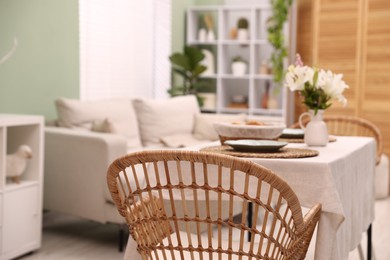 Photo of Stylish table with chairs and decor in dining room, closeup. Interior design