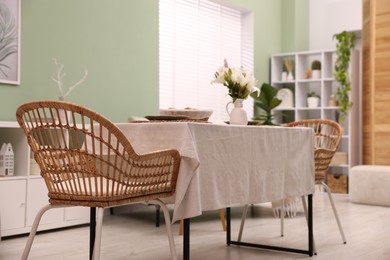Photo of Stylish table with chair and decor in dining room. Interior design
