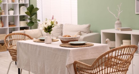 Photo of Stylish table with chairs and decor in dining room. Interior design