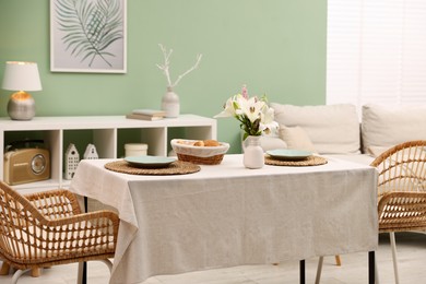 Photo of Stylish table with chairs and decor in dining room. Interior design