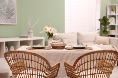 Photo of Stylish table with chairs and decor in dining room. Interior design