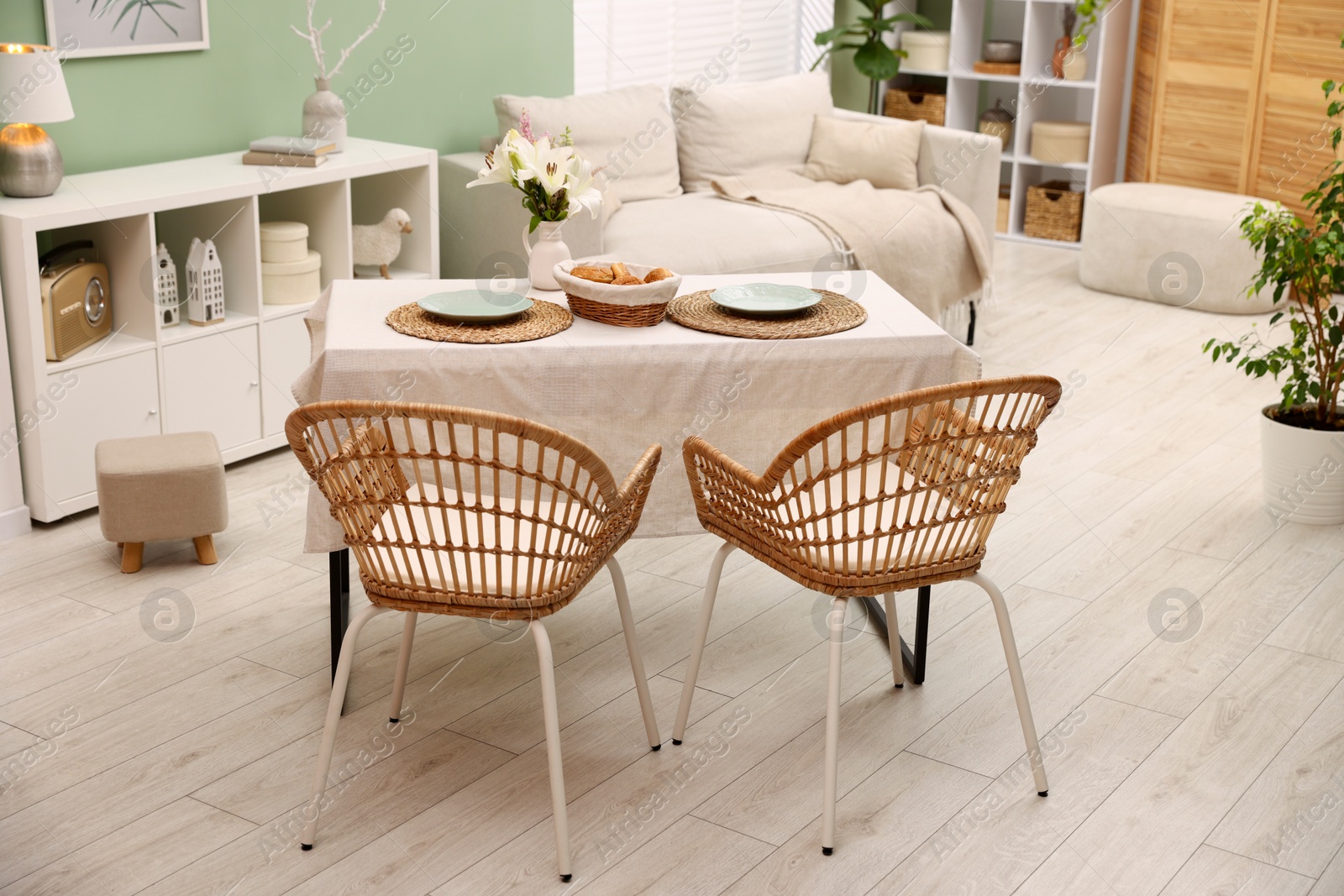 Photo of Stylish table with chairs and decor in dining room. Interior design