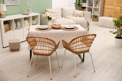 Photo of Stylish table with chairs and decor in dining room. Interior design