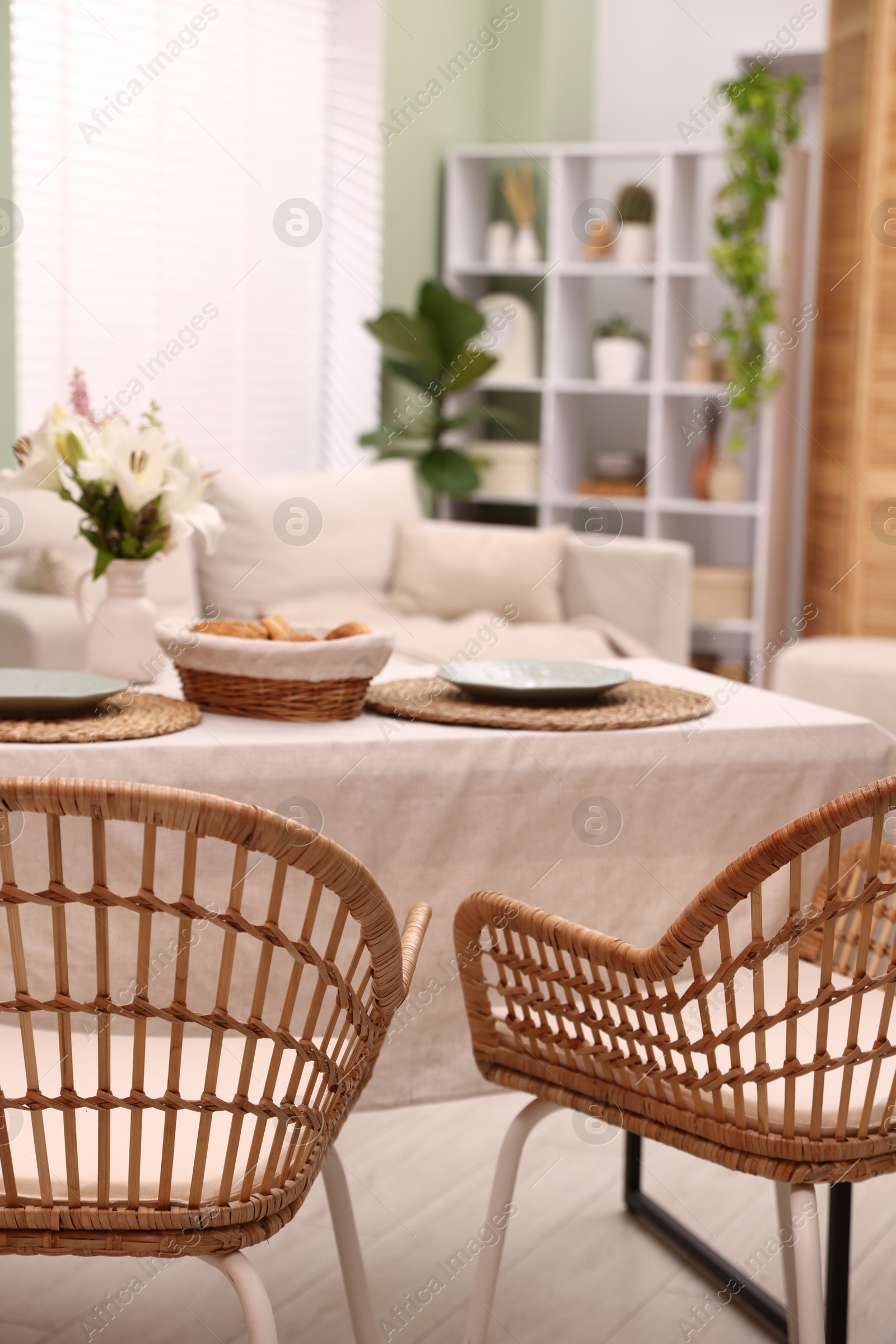 Photo of Stylish table with chairs and decor in dining room. Interior design