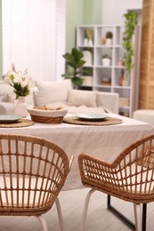 Photo of Stylish table with chairs and decor in dining room. Interior design