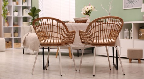 Photo of Stylish table with chairs and decor in dining room. Interior design