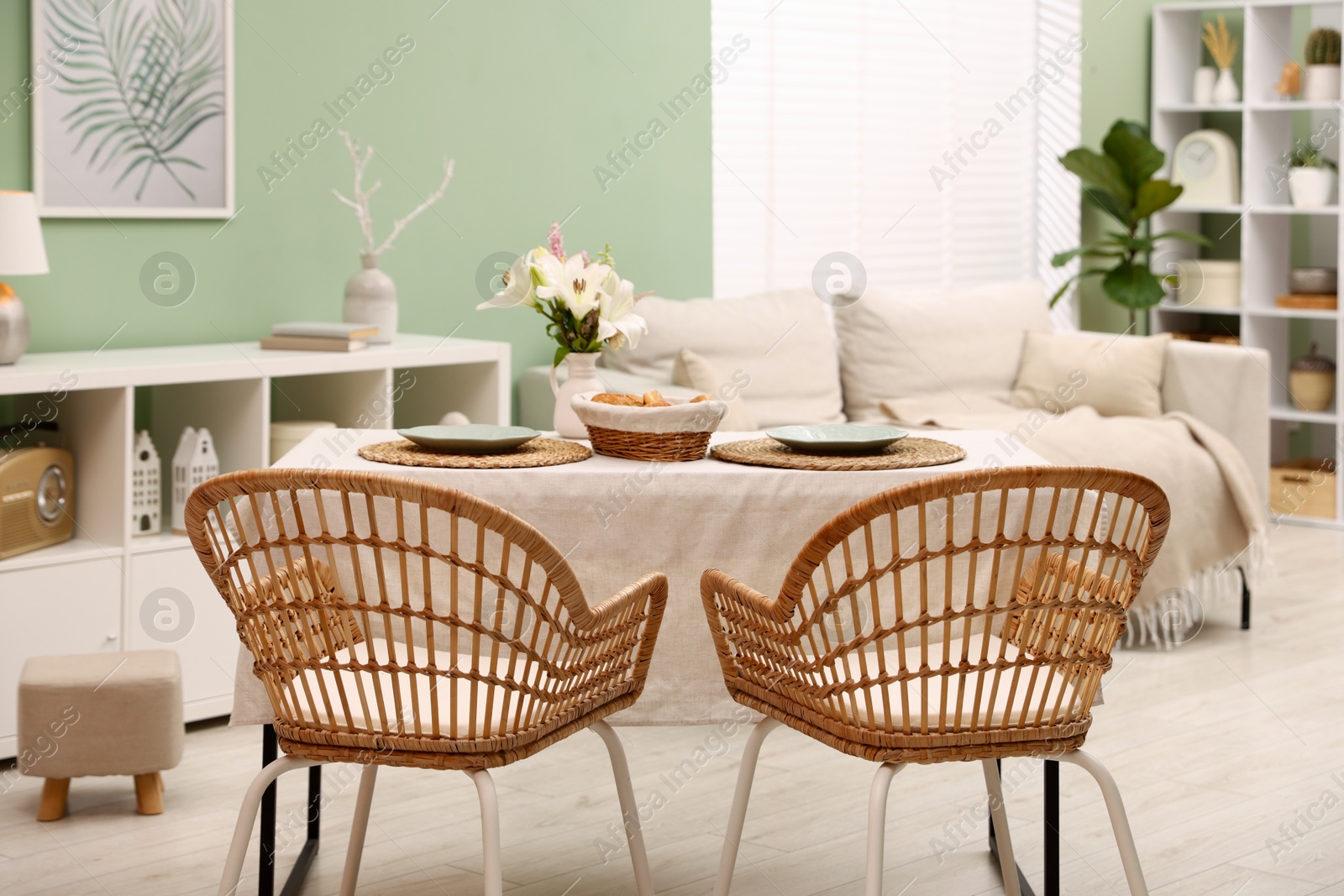 Photo of Stylish table with chairs and decor in dining room. Interior design