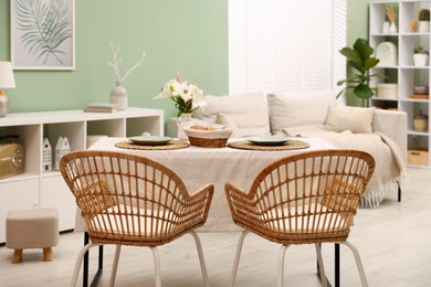 Photo of Stylish table with chairs and decor in dining room. Interior design
