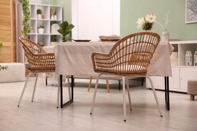 Photo of Stylish table with chairs and decor in dining room. Interior design
