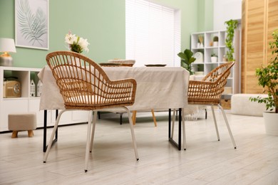 Photo of Stylish table with chairs and decor in dining room. Interior design