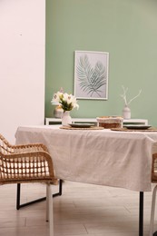 Photo of Stylish table with chair and decor in dining room. Interior design