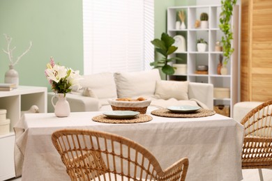 Photo of Stylish table with chairs and decor in dining room. Interior design