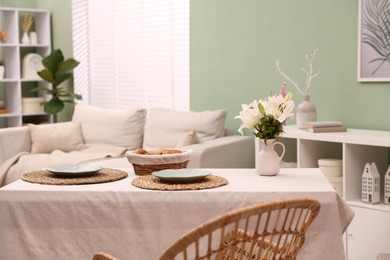 Photo of Stylish table with chair and decor in dining room. Interior design