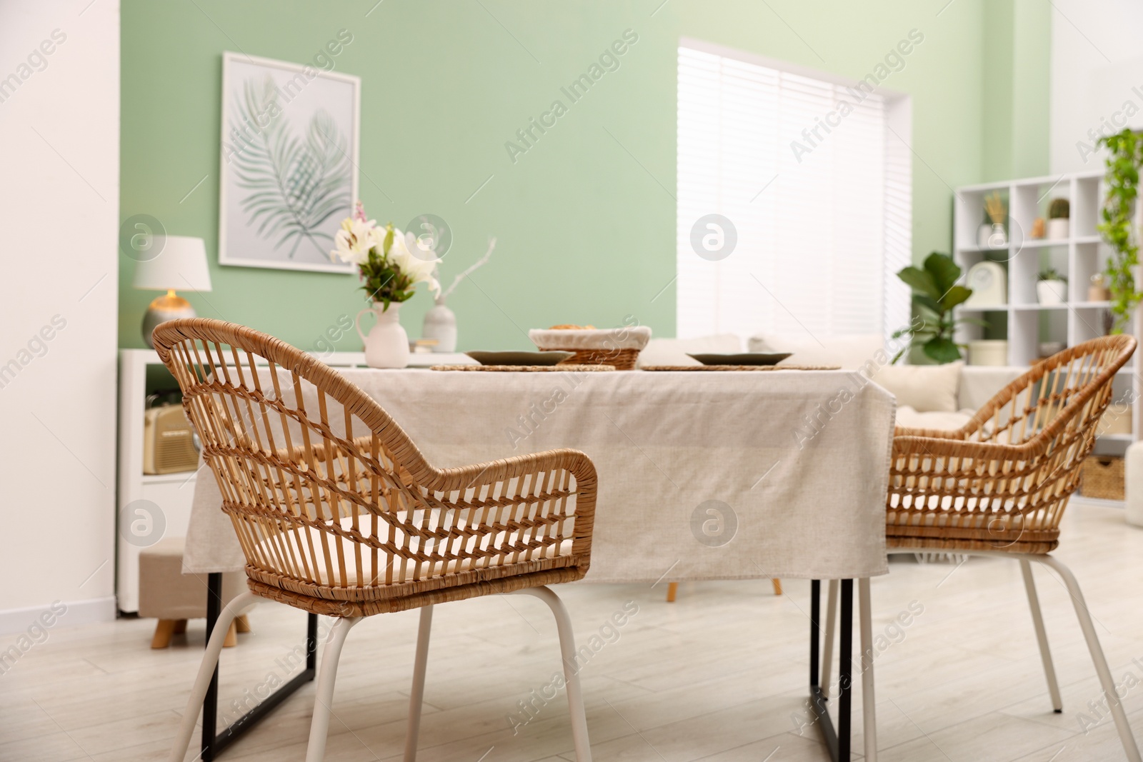 Stylish table with chairs and decor in dining room. Interior design Photo of Stylish table with chairs and decor in dining room. Interior design