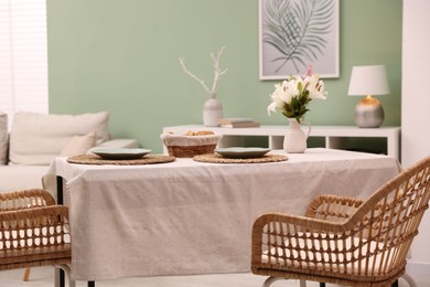 Photo of Stylish table with chairs and decor in dining room. Interior design