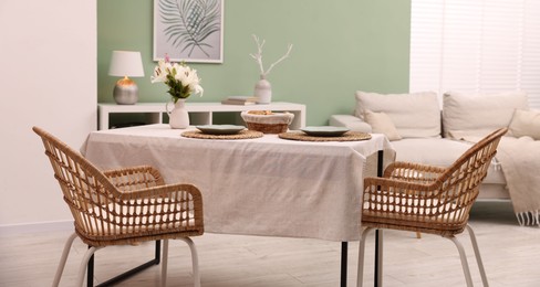 Photo of Stylish table with chairs and decor in dining room. Interior design