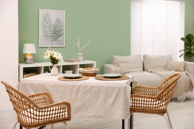 Photo of Stylish table with chairs and decor in dining room. Interior design