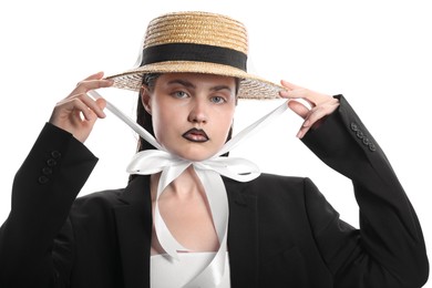 Photo of Beautiful young woman with black lip liner wearing straw hat on white background