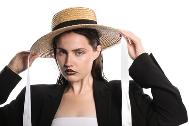 Photo of Beautiful young woman with black lip liner wearing straw hat on white background
