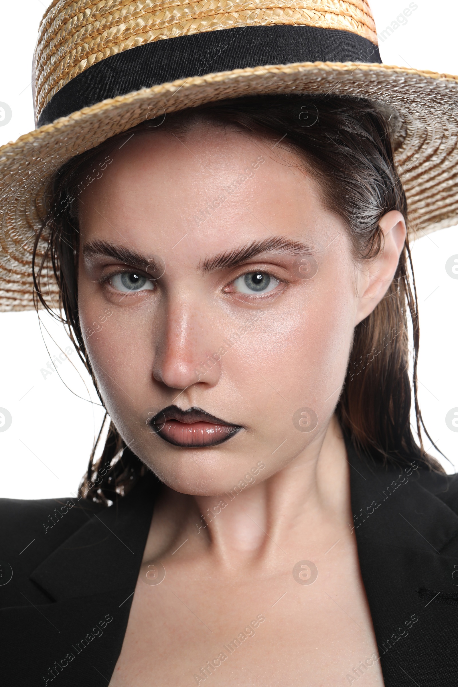 Photo of Beautiful young woman with black lip liner wearing straw hat on white background, closeup