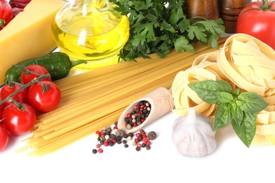 Photo of Different types of pasta and ingredients isolated on white