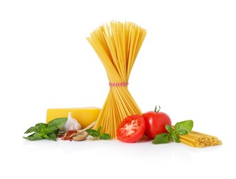 Photo of Raw spaghetti pasta and different ingredients isolated on white