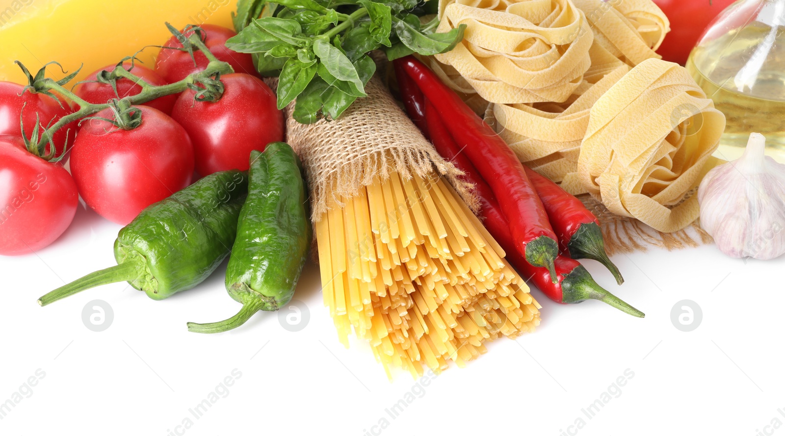 Photo of Different types of pasta and ingredients isolated on white