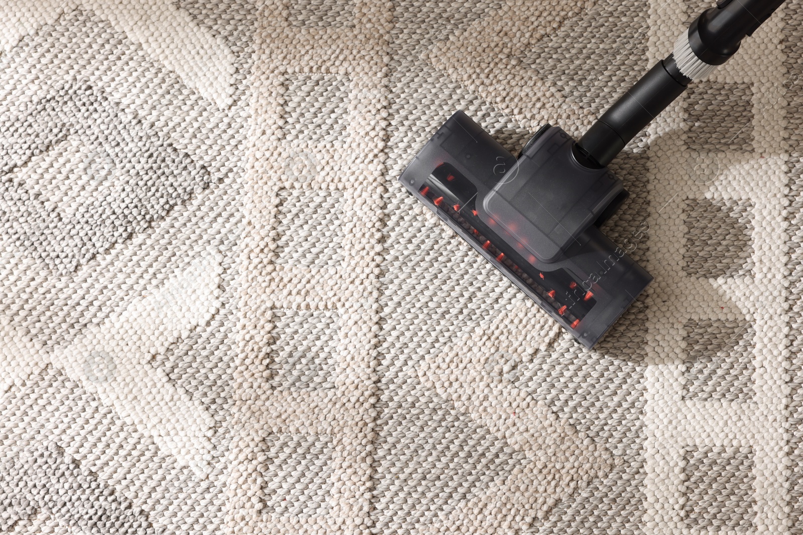 One vacuum cleaner nozzle on carpet, top view. Space for text Photo of One vacuum cleaner nozzle on carpet, top view. Space for text